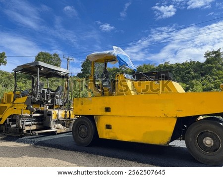 Similar – Foto Bild Arbeiter mit Asphaltfertigerwerkzeug beim Straßenbau.