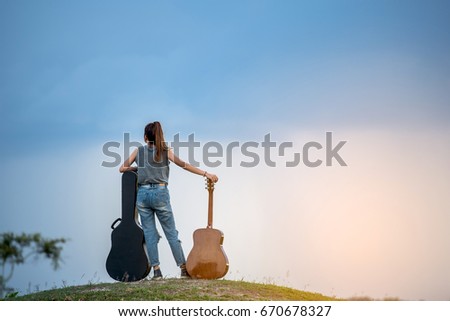 Similar – Image, Stock Photo Young hipster woman playing the guitar outside the forest park of the city. Having fun learning a new skill, music play seasonal style. Young short hair girl. Copy space