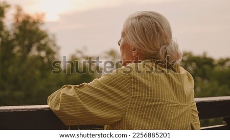 Similar – Image, Stock Photo Senior lady admiring sunset over ocean from boardwalk