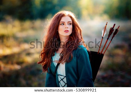 https://image.shutterstock.com/display_pic_with_logo/4087738/530899921/stock-photo-close-up-portrait-of-a-beautiful-red-haired-girl-in-green-medieval-dress-with-bow-and-arrows-530899921.jpg