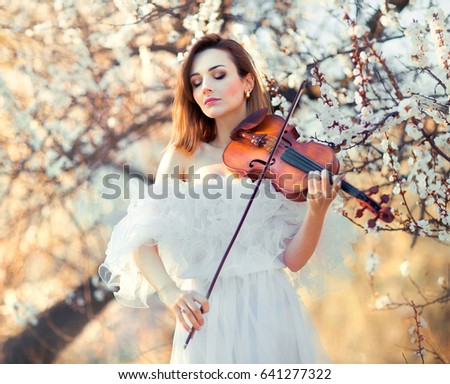 https://image.shutterstock.com/display_pic_with_logo/4087738/641277322/stock-photo-beautiful-romantic-girl-with-dark-hair-and-white-dress-playing-on-a-violin-in-spring-park-sad-641277322.jpg