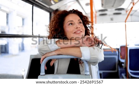 Similar – Image, Stock Photo Middle aged woman riding his electric scooter and looking at mobile phone.