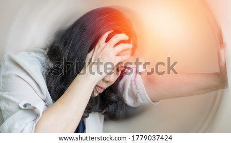 Vertigo illness concept. Woman hands on his head felling headache dizzy sense of spinning dizziness,a problem with the inner ear, brain, or sensory nerve pathway.