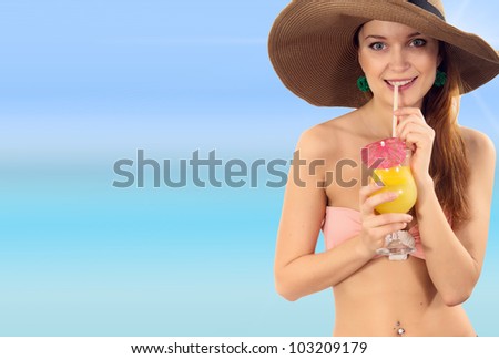 Beautiful woman in bikini drinks cocktail at Maldives island