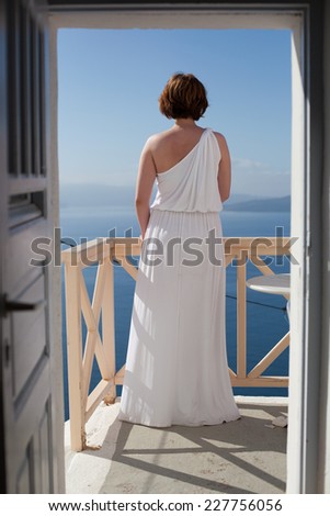 Bride standing back and enjoying sun on the tropic island