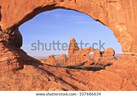 Turret Arch seen through the eye-shaped North Window at Arches National Park, Utah