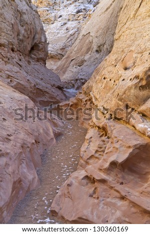 A hiking path winds through colorful Little Wild Horse Slot Canyon near Goblin Valley State Park in Utah