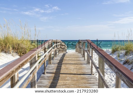The boardwalk leads to the turquoise waters of the Gulf of Mexico at Park West on the western end of Pensacola Beach, Florida.