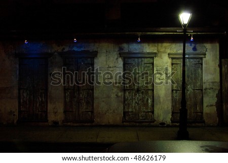 Aged and weathered storm shutters on the windows and doors of a French Quarter House in New Orleans, Louisiana