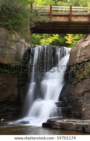 A rusty bridge crosses over Hardenburgh Falls as it falls into the Schoharie Reservoir in the Catskills Mountains of New York