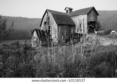 A black and white image of a dilapidated barn on Barkaboom road on a foggy morning in the Catskills Mountains of New York