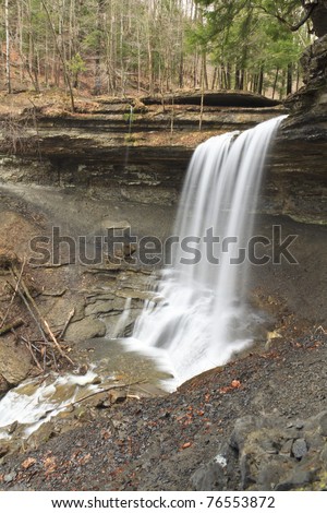 Water spills smoothly ofver a 50' overhang at Tinker Falls in Cortland County in New York State