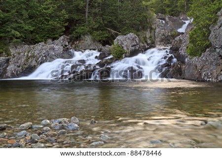Rocks and boulders divide a stream that tumbles into a pool at Split Rock Falls in the Adirondack Mountains of New York