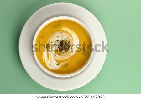 Similar – Image, Stock Photo Pumpkin creamy soup served on green leaf