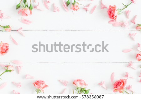 Photo of Spring flowers. Pink flowers on white wooden background. Flat lay, top view, copy space