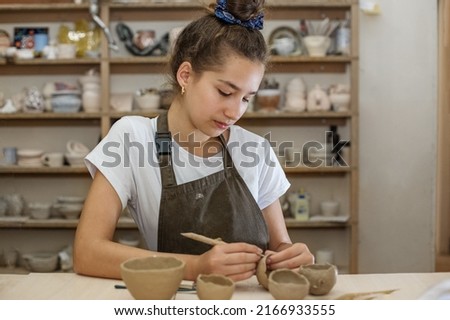 Similar – Image, Stock Photo Teenage girl working on school tasks homework remotely on her laptop from home during COVID-19 quarantine. Online course lessons. Learning remotely. Girl sitting on bed in front of computer looking at screen