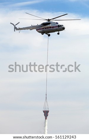 Similar – Image, Stock Photo A firefighting helicopter pours water into a forest to put out a forest fire