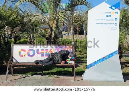SOCHI, RUSSIA - MAR 23, 2014: The HOMELESS man sleeping on a bench in the city street