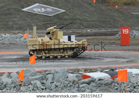 NIZHNY TAGIL, RUSSIA - SEP 25, 2013: The international exhibition of armament, military equipment and ammunition RUSSIA ARMS EXPO (RAE-2013). Remote controlled tracked robot machine gun