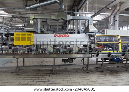 MOSCOW, RUSSIA, OCHAKOVO BREWERY - JUN 13, 2013: The biggest Russian company beer and beverage industry. Finished products - the packaging of glass bottles moving on conveyor
