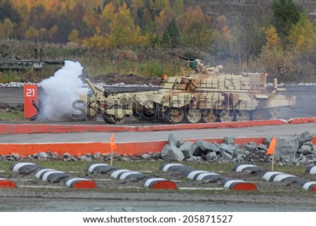 NIZHNY TAGIL, RUSSIA-SEP 25, 2013: The international exhibition of armament, military equipment and ammunition RUSSIA ARMS EXPO (RAE-2013). Armored vehicle for demining BMR3M going through a minefield