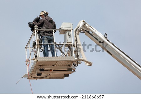 MOSCOW REGION, SERGIYEV POSAD, RUSSIA- JUL 18, 2014:  Videographer produces video report from the height of a crane on a celebration of the 700th anniversary of the birthday of St. Sergius of Radonezh