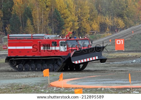 NIZHNY TAGIL, RUSSIA - SEP 26, 2013: The international exhibition of armament, military equipment and ammunition RUSSIA ARMS EXPO (RAE-2013). Caterpillar fire truck to extinguish forest fires
