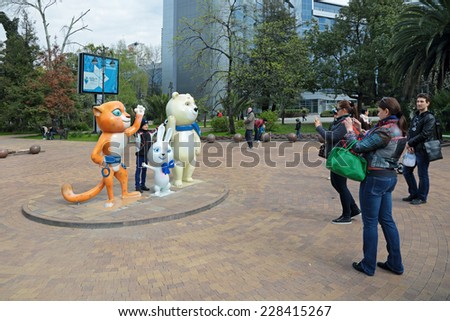 SOCHI, RUSSIA - MAR 28, 2014: The urban cityscape. People are being photographed on the background of sculptural composition - the symbols of the Olympic winter games of 2014 in a city street