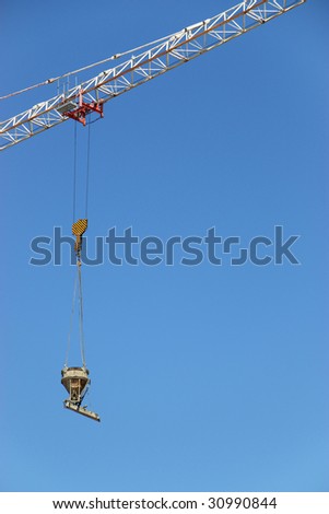 Fragment of a steel design of the hoisting crane and the attached cargo
