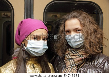 MOSCOW - NOVEMBER 7: People in the Moscow underground put on masks to protect themselves from a virus H5N1 on November 7, 2009 in Moscow, Russia.