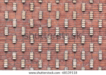 Structure of a brick wall from a red and white brick with an unusual laying