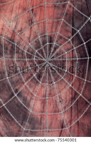 Scenery from a red-brown background with the steel chain tense before it in the form of a web