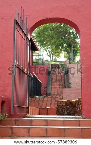an open gate leading to st. paul\'s hill in malacca, malaysia