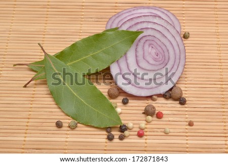 Onion and spices on a bamboo napkin.