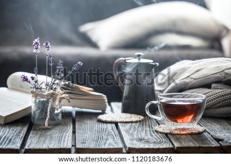 still life book and a cup of tea in the living room on a wooden table, the concept of coziness and interior Stockfoto © 