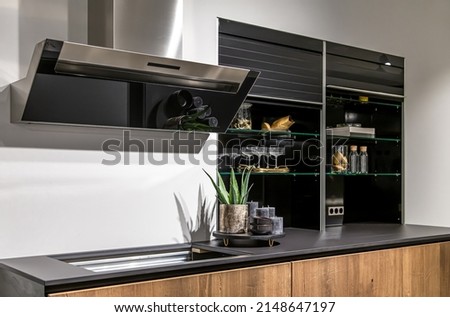 Part of the interior of a modern kitchen, a place for cooking, an extractor hood and a stove. ストックフォト © 