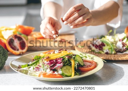 Similar – Image, Stock Photo A stylish chef in a black jacket prepares tasty salad with ripe figs, goat Chevre cheese, fresh cucumber roll, beetroot and mustard leaves with tomato sauce. Restaurant dish. Delicious food