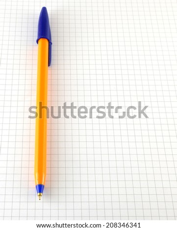 One pen on the checked paper of notepad