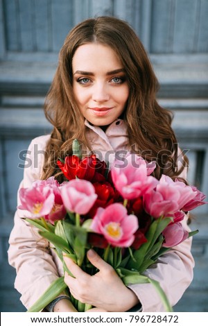 https://image.shutterstock.com/display_pic_with_logo/4116337/796728472/stock-photo-lovely-cute-amazing-brunette-girl-standing-in-front-of-old-vintage-blue-door-with-a-bouquet-of-796728472.jpg