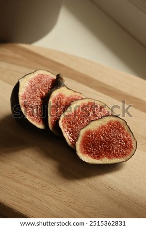 Similar – Ripe figs cut on a pink background. Minimal flat lay.