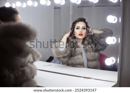 Similar – Image, Stock Photo A glamorous girl in an elegant dress walks along a deserted road with a bag in her hand.