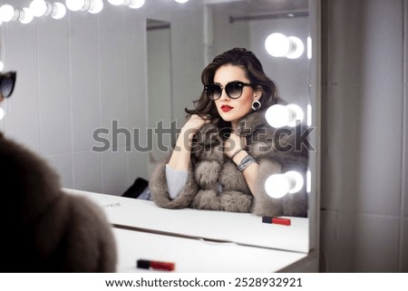 Similar – Image, Stock Photo A glamorous girl in an elegant dress walks along a deserted road with a bag in her hand.