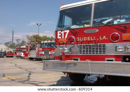 A set of fire trucks lined up in a parking lot after Katrina. Taken in Slidell, LA