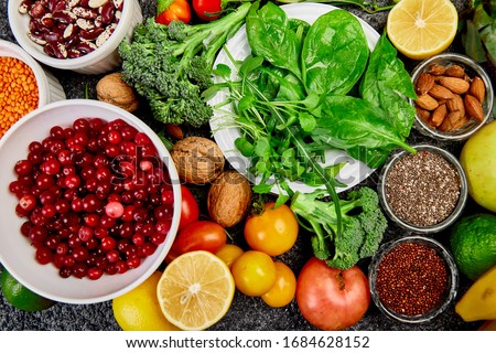 Healthy food background, trendy Virus protection food, coronavirus, immunity concept. Alkaline diet products - fruits, vegetables, cereals, nuts, oils, dark grey concrete background. Top view.