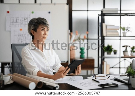 Similar – Image, Stock Photo Cheerful businesswoman browsing tablet in office