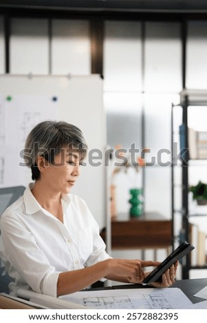 Similar – Image, Stock Photo Cheerful businesswoman browsing tablet in office