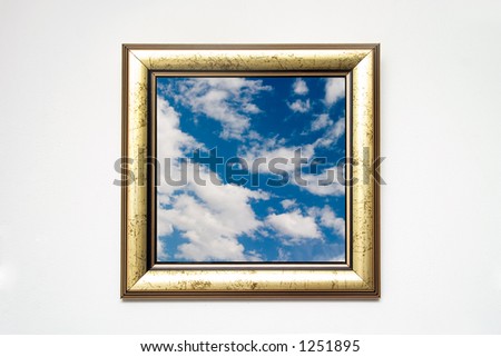 golden picture frame with cloudscape shot on white wall, cloudscape photo is mine