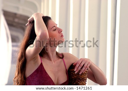 Beautiful brunette sweeps her hands through her hair