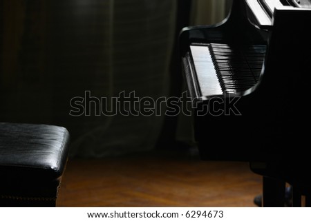 Piano and chair in strong back light, waiting for piano player