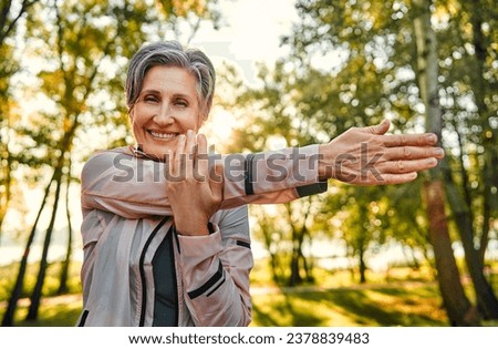 Similar – Image, Stock Photo fit senior lady dressed in black by the lake